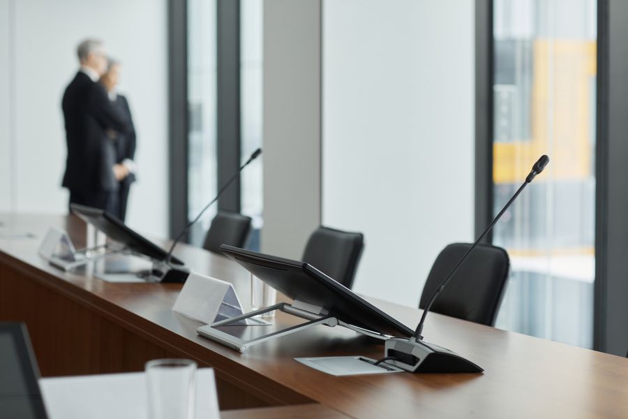 Microphones and chairs around a conference table